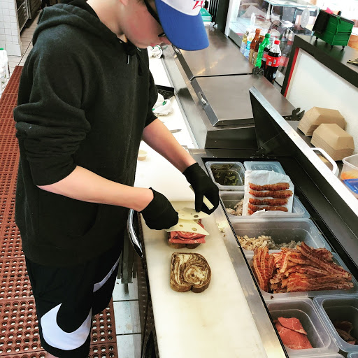 Doug McCulloch’s son, Henry, prepares a sandwich at the Winkin’ Rooster. 
